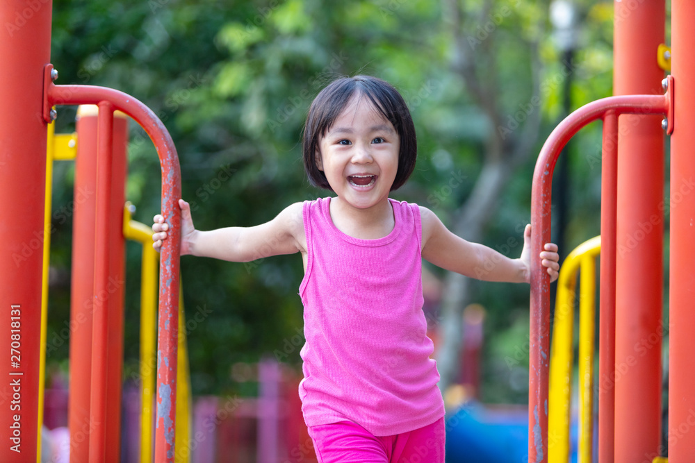 Fototapeta premium Asian Chinese little girl playing at outdoor playground