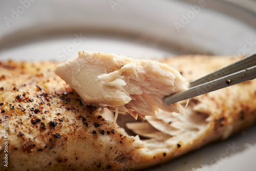 Grilled mackerel fish, eating with chopsticks