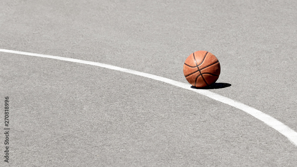 Basketball ball on asphalt with white markings. Basketball ball on asphalt with white markings.