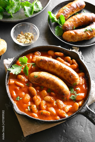 Baked white beans in tomato sauce with sausages