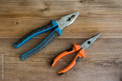 pliers on wooden background