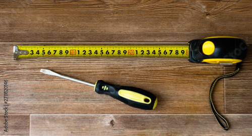 a tape measure and a screwdriver