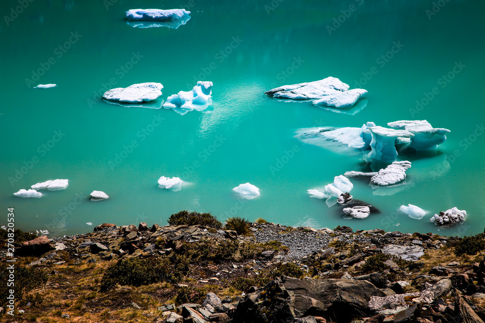 Floating glacial ice sheets and ice formations in Hooker Lake, New Zealand.