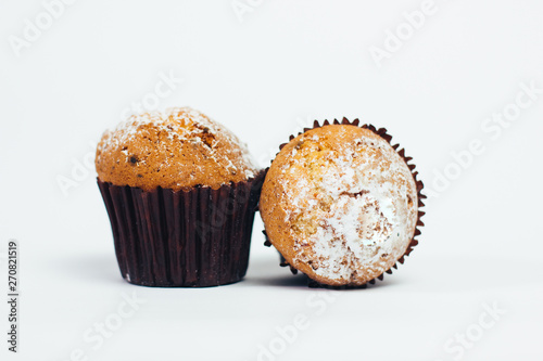 two muffin with sugar powder on white background