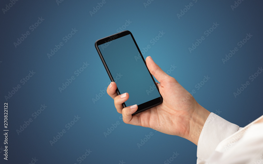 Mockup for female hand using frameless smartphone with dark background
