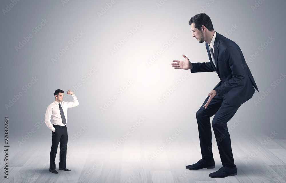 Big debutant young businessman scared of small strong businessman
Big debutant young businessman scared of small strong businessman