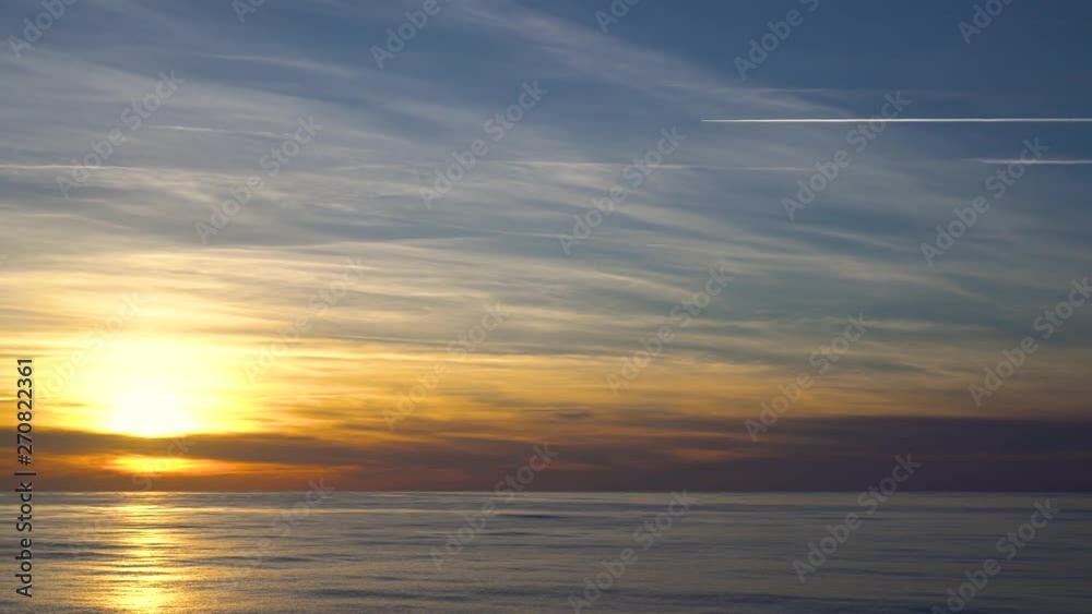 Orange flame sunset landscape with sun reflected in the water Orange flame sunset landscape with sun reflected in the water
