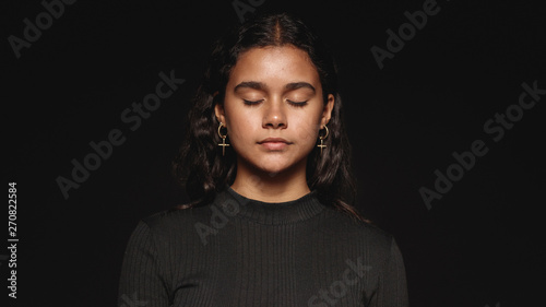 Young woman with eyes closed