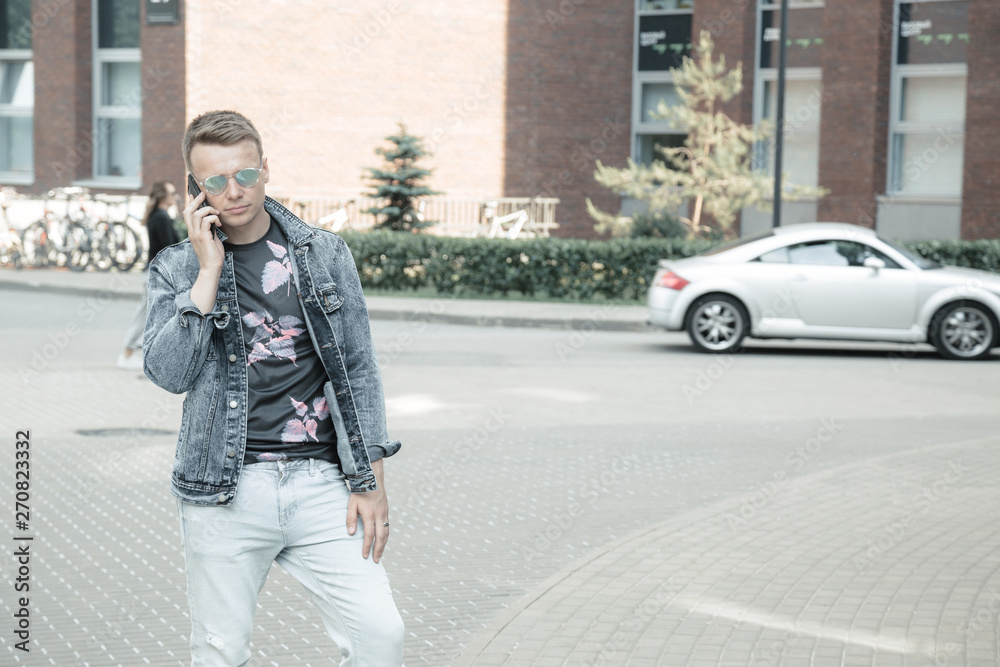 Young man on the street with a smartphone