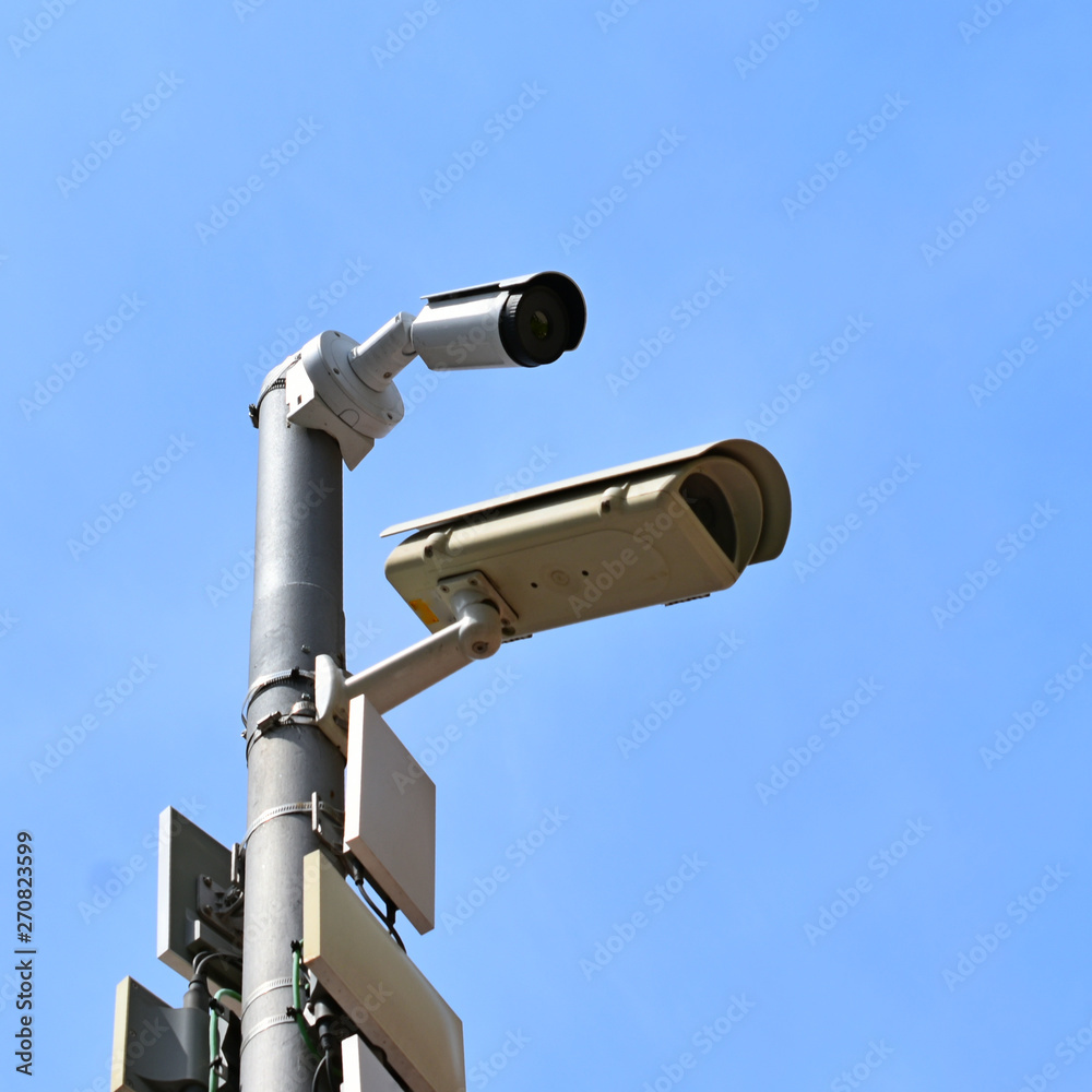 security cameras two pieces against a blue sky security cameras two pieces against a blue sky
