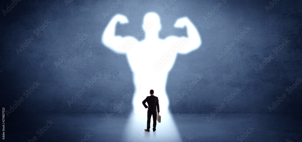 Businessman standing and dreaming about a strong superhero Businessman standing and dreaming about a strong superhero
