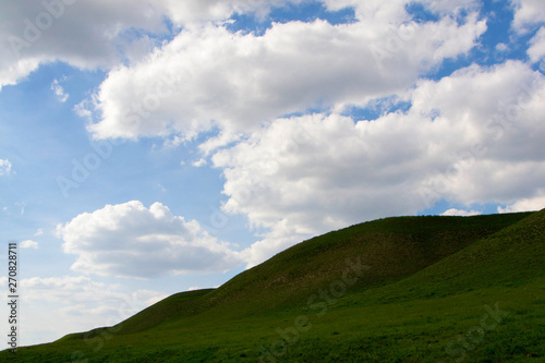 Fototapeta Naklejka Na Ścianę i Meble -  Mountain, sky and fluffy clouds