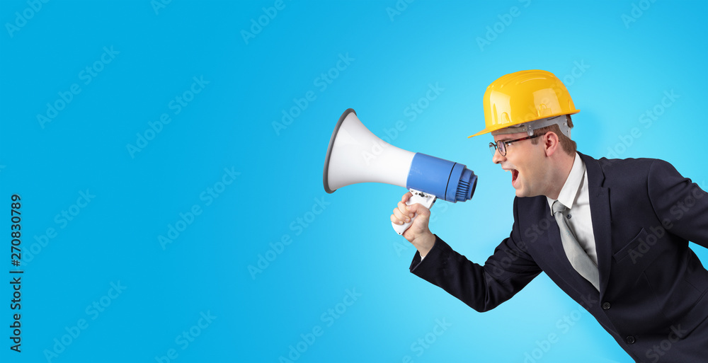 Young architect constructor yelling with megaphone and copyspace Young architect constructor yelling with megaphone and copyspace