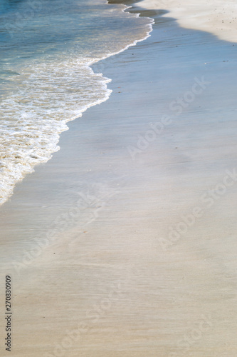 Waves lapping a sandy beach on the Caribbean island of Antigua