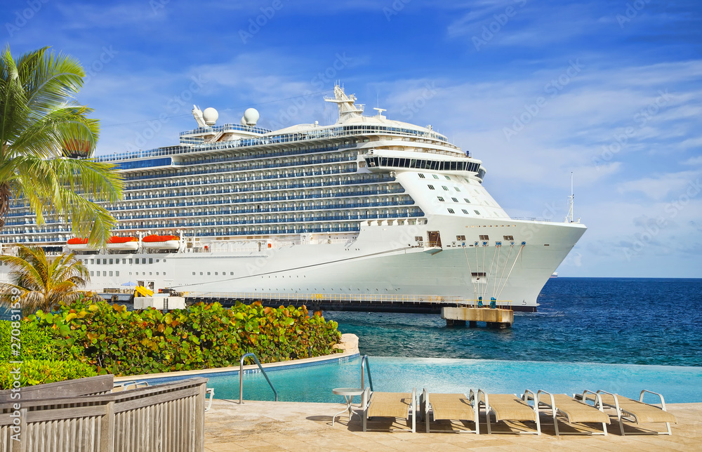 View from pool at tropical resort on cruise ship docked at port 