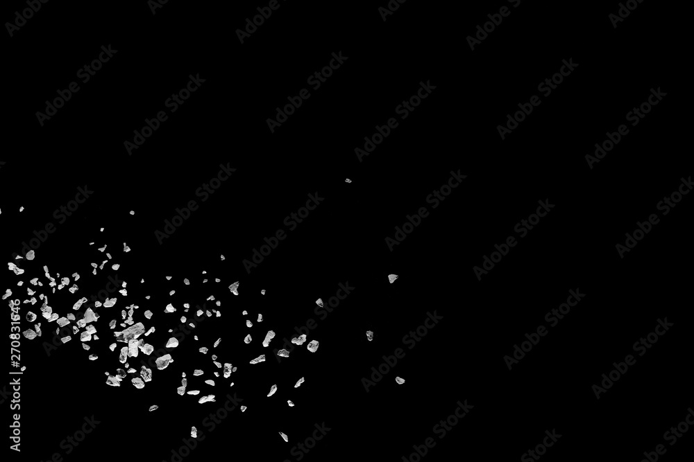 Split debris of stone exploding against black background. Split debris of stone exploding against black background.
