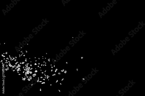 Split debris of stone exploding against black background.