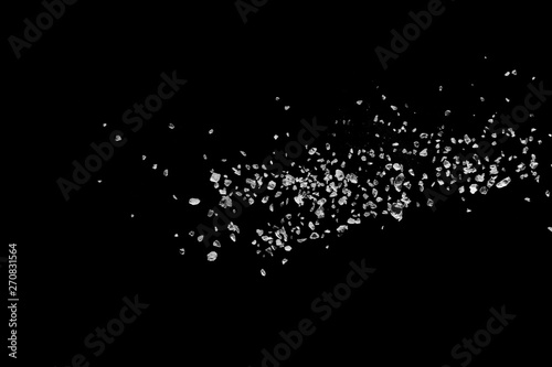 Schilderij op canvas Split debris of stone exploding against black background.