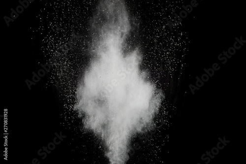 White powder explosion.Freeze motion of white dust particles on black background.