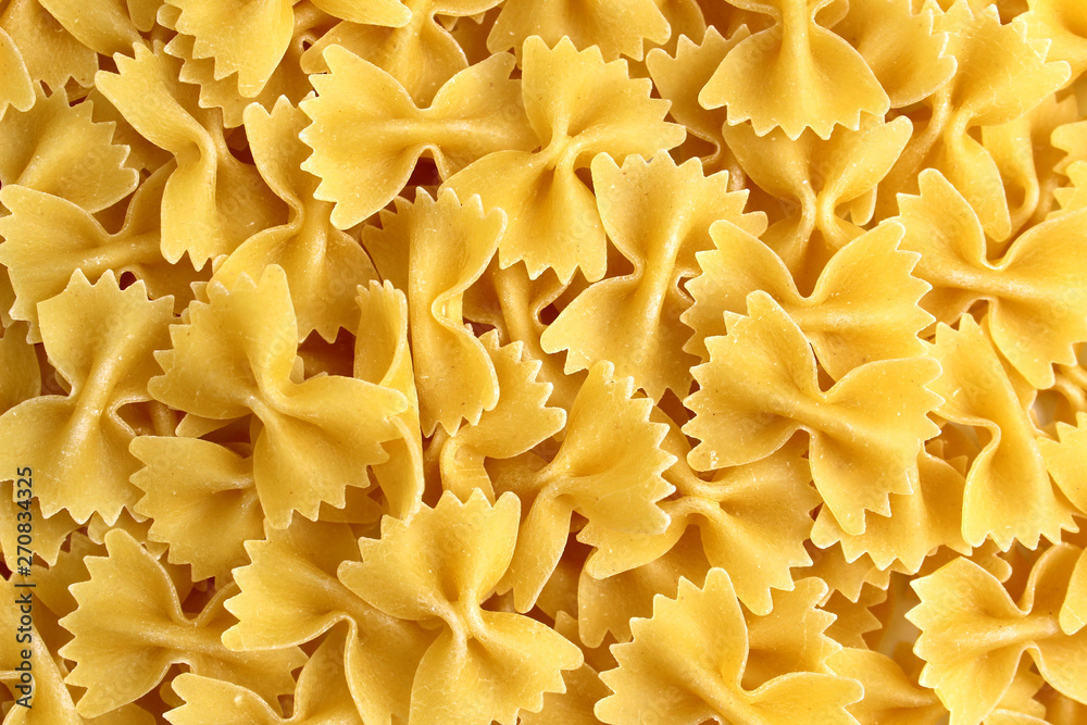 The texture of pasta in the form of a bow on a pink background The texture of pasta in the form of a bow on a pink background