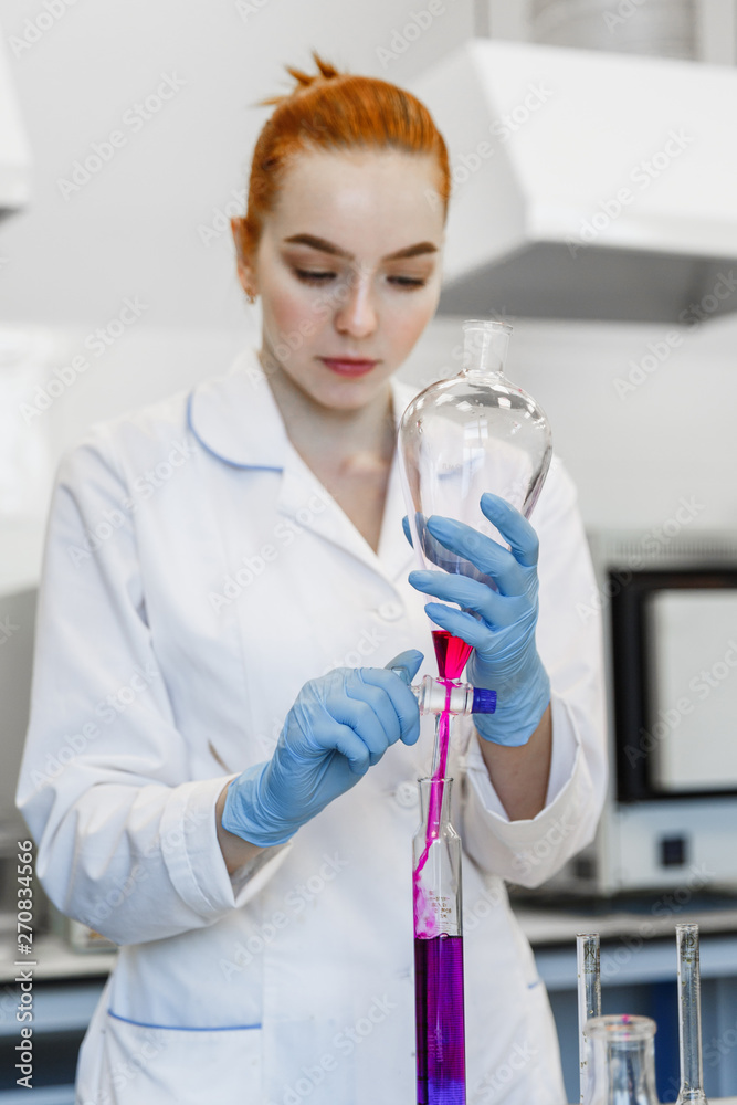 Fototapeta premium red-haired woman works in the medical laboratory