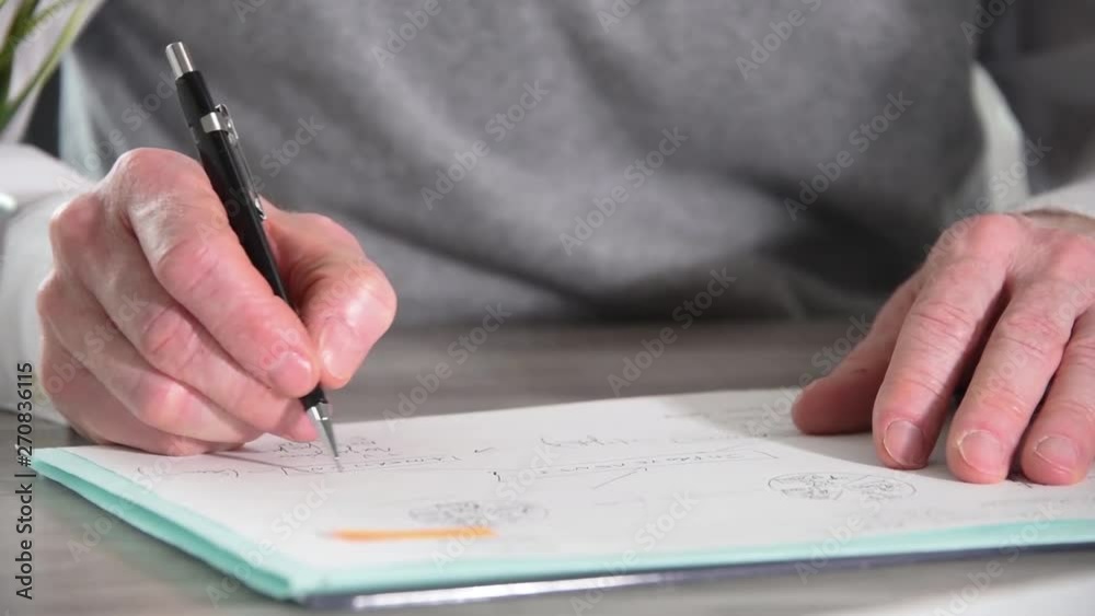 Businessman working on document and typing on laptop, close-up