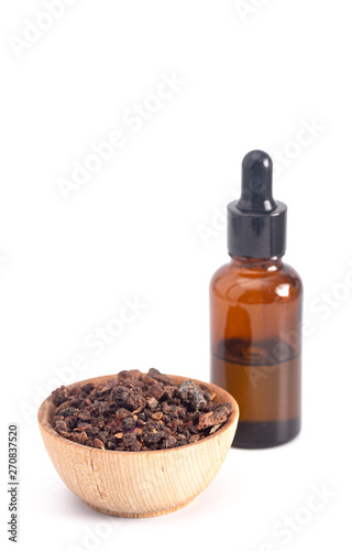 Bowl of Myrrh with a Bottle of Essential Oil on a White Background