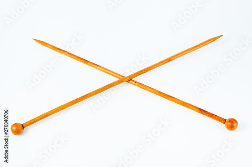 Pair of wooden knitting needles - white background