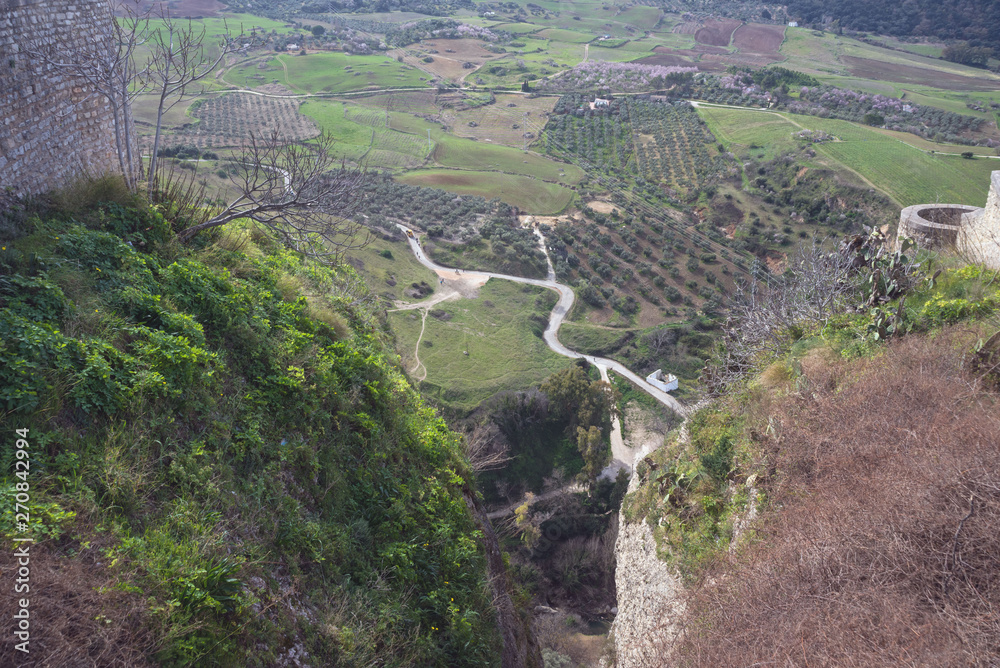 Obraz premium Beautiful city on top of a mountain in the Spanish province of Malaga in Andalusia. View of the valley. Tourists admire the scenery.