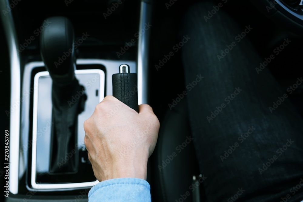 Men use hands to pull the parking brake