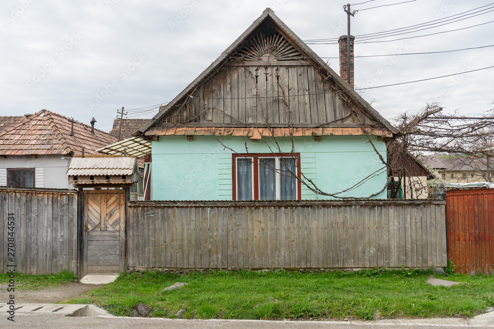 Traditional old house with front fence in a town. Rural scene. Traditional old house with front fence in a town. Rural scene.