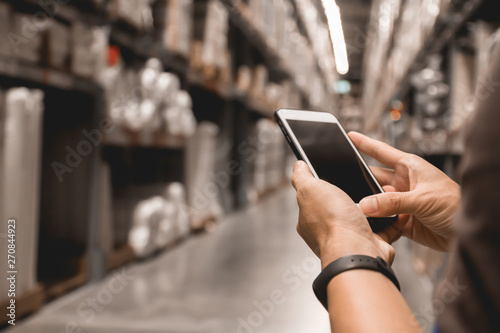 Close up business man hand holding blank screen mobile smart phone checking and contacts business logistics with warehouse background wholesale factory warehouse management, smart logistic, business, 
