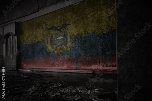 painted flag of ecuador on the dirty old wall in an abandoned ruined house
