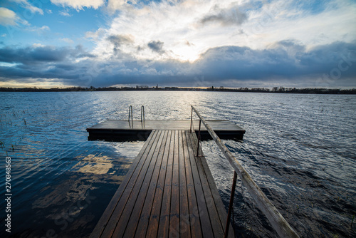 clear sky with dramatic clouds over the lake in sunset