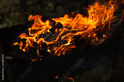 Fire and wood in the grill are burning