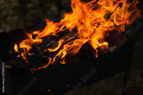 Fire and wood in the grill are burning