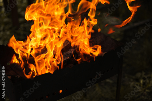 Fire and wood in the grill are burning