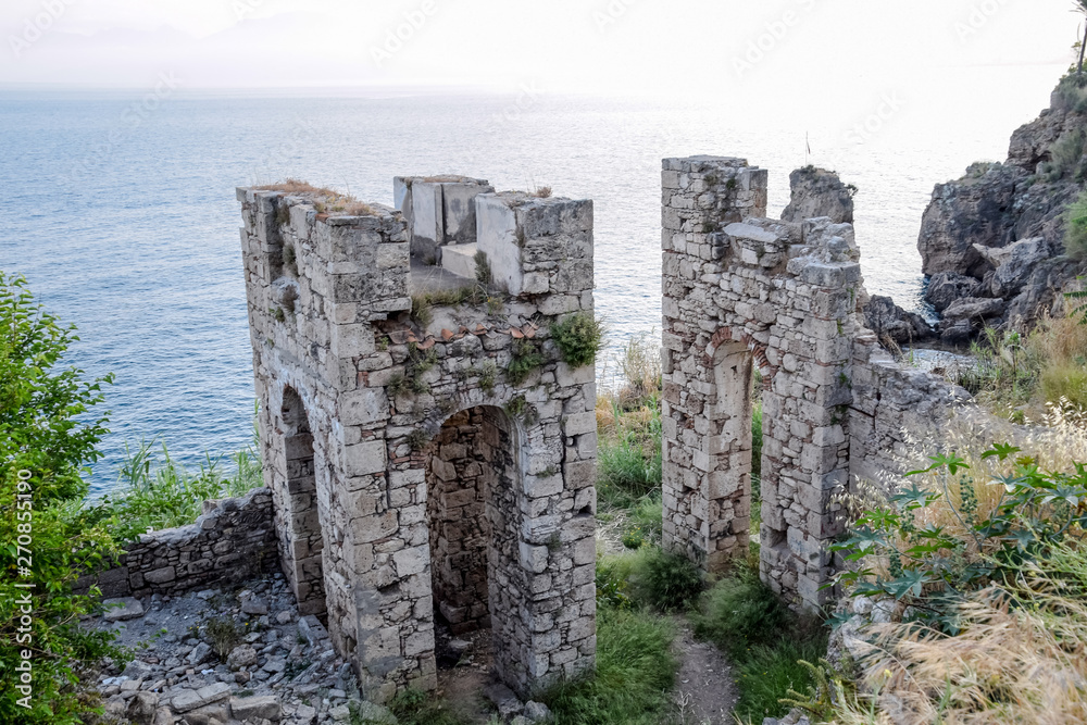 Ruins of ancient buildings on coast of Antalya. Ancient buildings by the sea.
