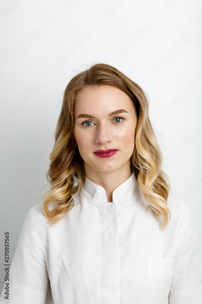 Portrait of a female doctor. Young female doctor on white background close up Portrait of a female doctor. Young female doctor on white background close up