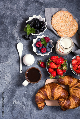 Healthy breakfast with, crisp bread, croissants, berries, coffee. Balanced diet and morning meal