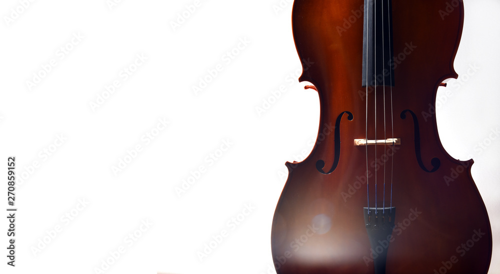 Fototapeta Cello in dramatic light with empty space and lens flare