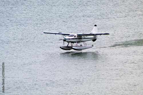Canvas Print small cessna plane landing on the alaska sea