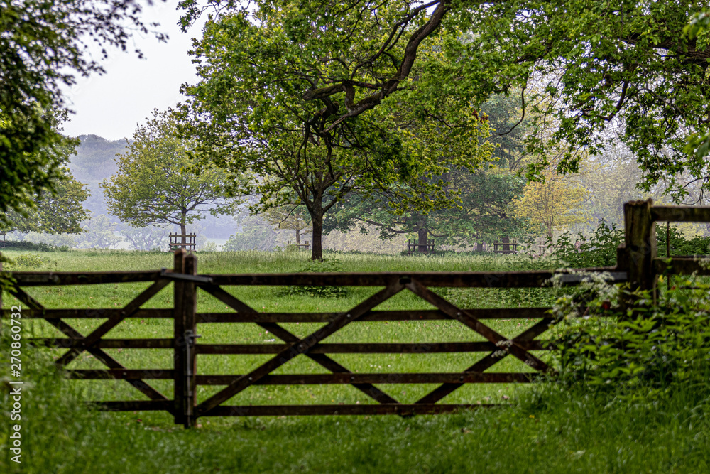 old wooden gate to farm land from the park old wooden gate to farm land from the park