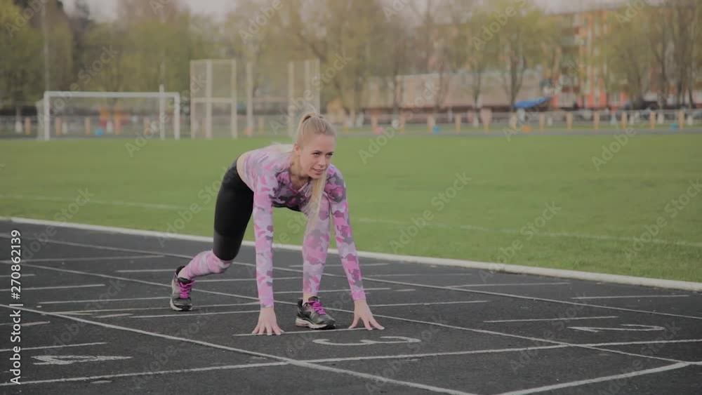 Girl preparing to run at the city stadium. Girl preparing to run at the city stadium.