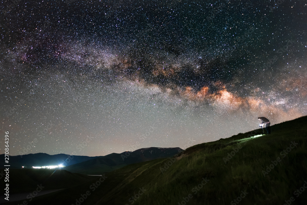 The space of the universe. Beautiful panoramic view of the the lake and mountain with Milky Way galaxy. 