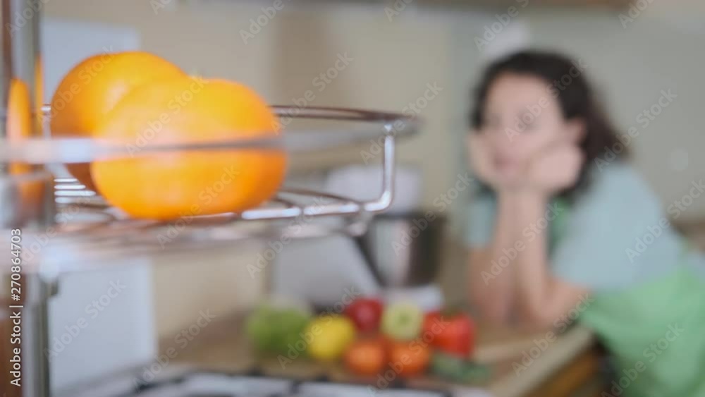 Enjoy the vitamins. Pretty woman with fresh vegetables in the kitchen. Enjoy the vitamins. Pretty woman with fresh vegetables in the kitchen.