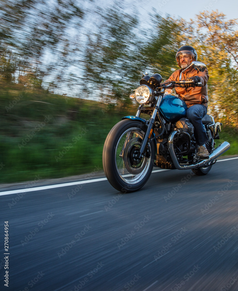 Motorcycle driver riding in Alpine highway, Nockalmstrasse, Austria, central Europe. Motorcycle driver riding in Alpine highway, Nockalmstrasse, Austria, central Europe.