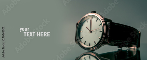 Elegant wrist watch closeup on dark photo