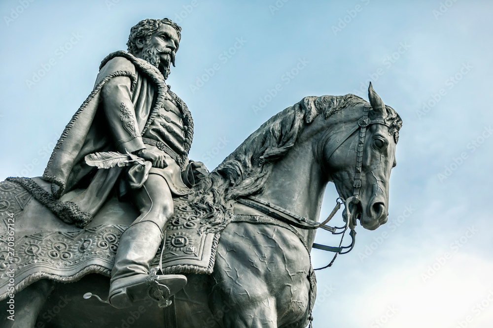 Horseman on horseback iron monument on the blue sea background Horseman on horseback iron monument on the blue sea background