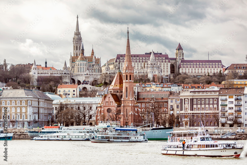 View of Fisherman's Bastion and the church of St. Matthias from the east side of Danube with motor ships on it